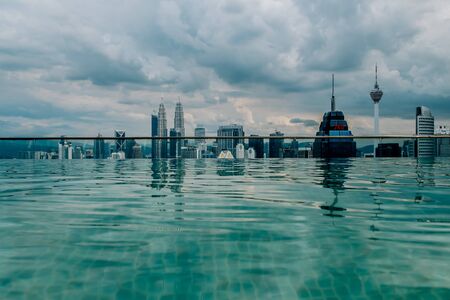 Nov 2018. Petronas Twin towers seen from skyscrapper's roof with pool, Kuala Lumpur central park, KLCCのeditorial素材