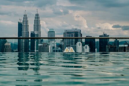 Nov 2018. Petronas Twin towers seen from skyscrapper's roof with pool, Kuala Lumpur central park, KLCCのeditorial素材