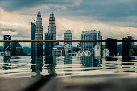 Nov 2018. Petronas Twin towers seen from skyscrapper's roof with pool, Kuala Lumpur central park, KLCCのeditorial素材