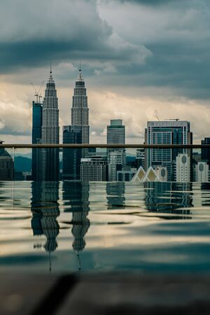 Nov 2018. Petronas Twin towers seen from skyscrapper's roof with pool, Kuala Lumpur central park, KLCCのeditorial素材