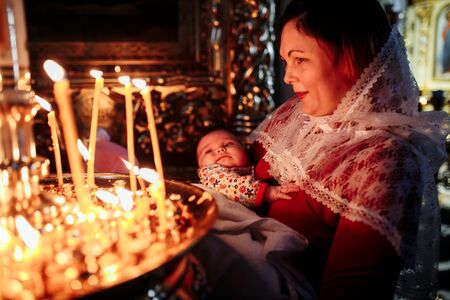 Dec 2018, Mother and child in church looking at candlesのeditorial素材