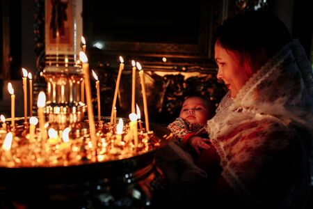 Dec 2018, Mother and child in church looking at candlesのeditorial素材