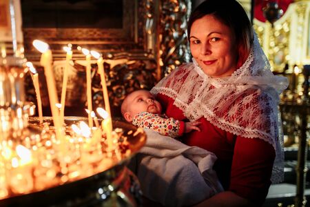 Dec 2018, Mother and child in church looking at candlesのeditorial素材