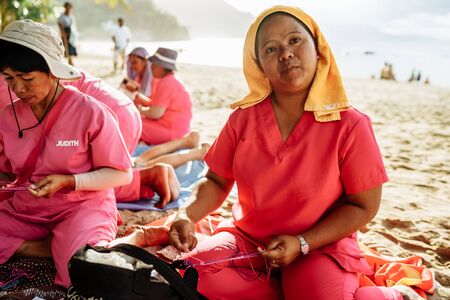 Bohol Island, Philippines- 5/11/2016 Tourists were enjoying massage service under a palm tree on the beach.Massage business was a common business on the beach in Mindoro Island.のeditorial素材