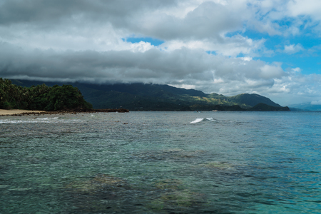Beautiful sandy beach with pristine, turquoise sea and coconut trees, Puerto Galera, Mindoro, Philippinesの写真素材