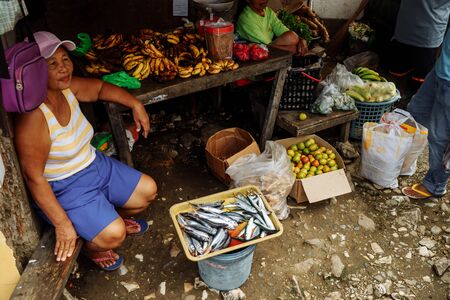 Puerto Galera, Philippines - Nov, 2018: Woman selling fish on the marketのeditorial素材