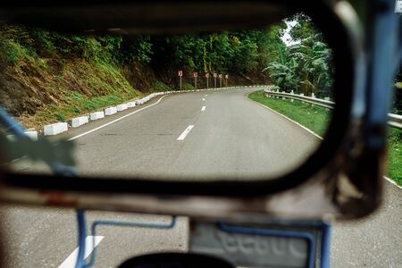 Mindoro Philippines - December 2018: View from Tricycle bike taxi. Tricycle are the most popular public transportation in the Philippines.のeditorial素材