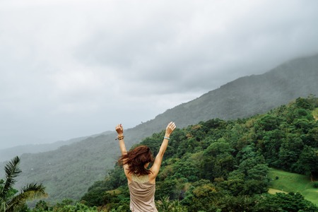 freedom girl with hands up in mountains. Mindoro, Philippinesの写真素材