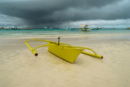 Yelow boat in the sea with clouds and blue sky at Boracay Island, Philippines. For nature background.の写真素材