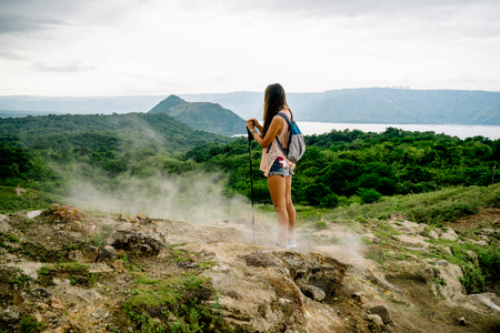 girl standing at taal volcano from trail along rim near manila in the philippinesの写真素材