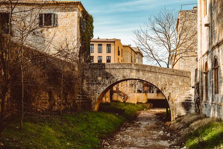 Bridges across the former moat in the park of the old city in Girona, Spain, medieval beauty.の写真素材