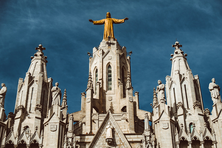 Sculpture of the Sacred Heart of Jesus on the Sagrat Cor church in Tibidabo mountain over Barcelona, Spainの写真素材