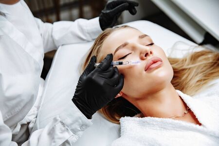 Non-surgical cosmetology. Filler injections. Correction of the shape of the upper lip.の写真素材
