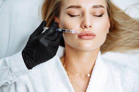 Injections of the lips. Correction form the upper lip. Injection of beauty. Spa. Facial Rejuvenation. Lip augmentation.の写真素材