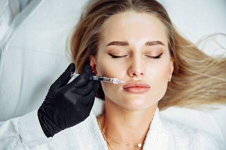 Injections of the lips. Correction form the upper lip. Injection of beauty. Spa. Facial Rejuvenation. Lip augmentation.の写真素材