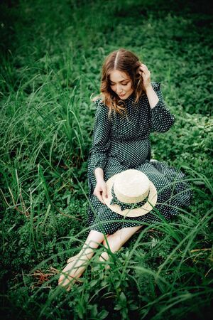 Young pregnant woman relaxing in park outdoors, healthy pregnancy.の写真素材