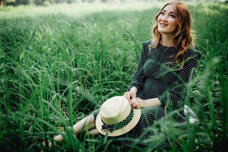 Pregnant woman posing in a green park. young happy pregnant woman relaxing and enjoying life in natureの写真素材
