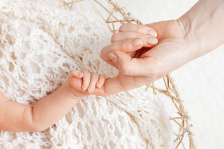 Parent hands holding newborn baby fingers, Close up mother's hand holding their new born baby. Love family healthcare and medical body part.の写真素材