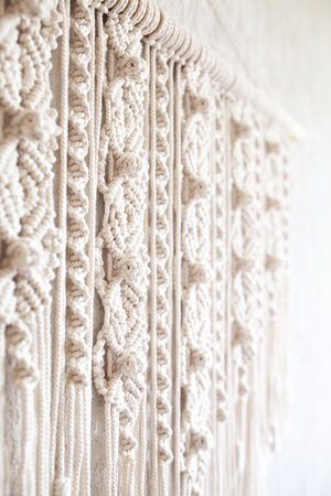 Close-up of hand made macrame texture pattern. ECO friendly modern knitting DIY natural decoration concept in the interior. Handmade 100% cotton, female hobby.の写真素材