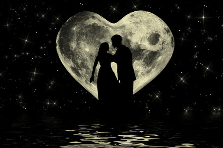Romantic valentine atmosphere with couple enjoying in the  heart shaped moonlightの写真素材