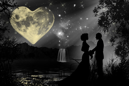 Valentine romantic atmosphere with heart shaped moon and a silhouette of a couple holding handsの写真素材