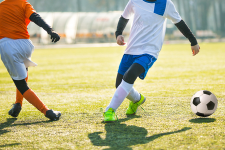 Football soccer match for children. Boys playing footballの写真素材