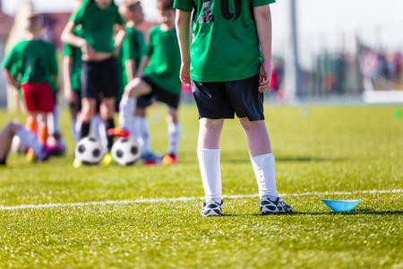 Football soccer training for children. Young boys preparing to the final game of soccer tournament.の写真素材