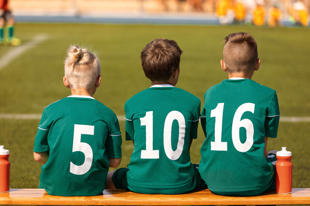 Kids Football Team. Soccer children watching game. Football soccer tournament match for children....