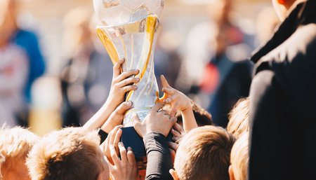 Close-up of Kids Sports Team with Trophy. Boys Celebrating Sports Achievement. Team Sports...