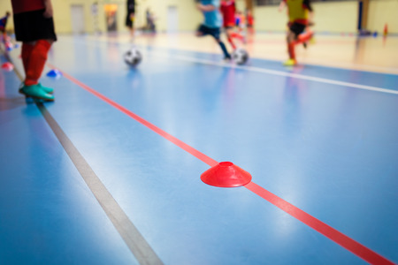 Group of Kids Training Indoor Soccer Futsal. Children Physical Education Class. Gym Class for Youth. Futsal Training Picture with Blurred Backgroundの写真素材