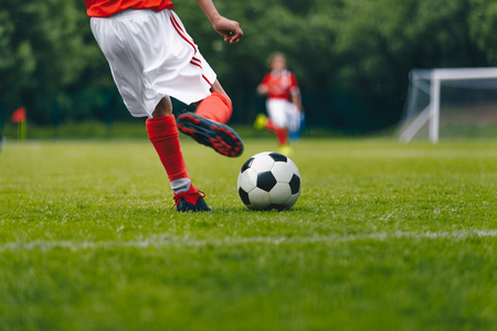 Football Kick on the Field. Player Kicking Soccer Ballの写真素材