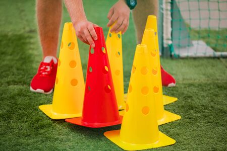 Soccer Coach Preparing Training Cones.Agility, Fitness and Power Training Equipment for Football Players. Soccer Practice Backgroundの写真素材