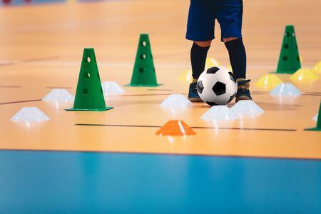 Indoor soccer players training with balls. Indoor soccer sports hall. Futsal league. Indoor football futsal player, ball, futsal floor and red cone. Futsal training dribbling drill. Sports backgroundの写真素材