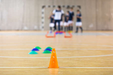 Futsal Training Field. Indoor Soccer Practice Session. Kids with Coach Training Footballの写真素材