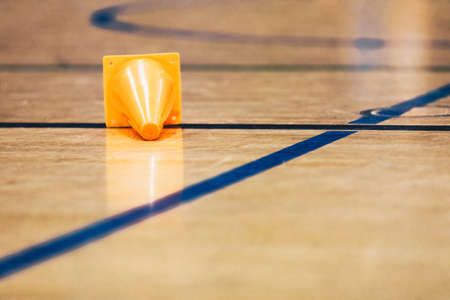 Orange Sports Training Field Lying on Shiny Surface of Wooden Sports Floor. Indoor Soccer, Basketball Training Fieldの写真素材