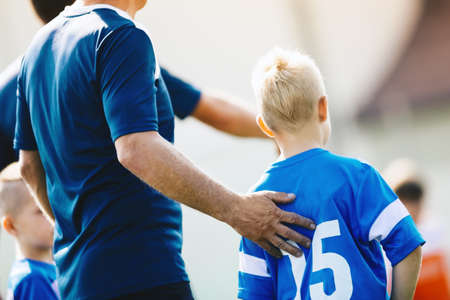 Sport Coach Supporting Young Player. Child Soccer Player Entering Game From Bench. Football Coach Trainer Coaching School Boys Teamの写真素材