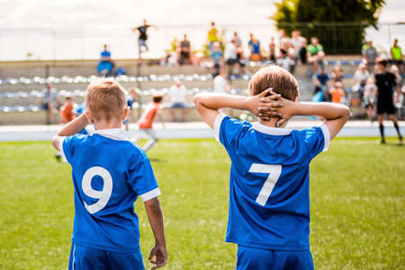 Sports Boys on Soccer Game. Kids in a Team Wearing Blue Jersey Shirts With Players Numbersの写真素材