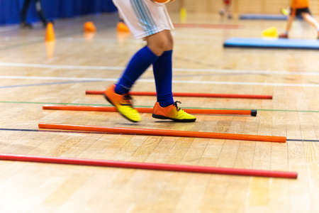 Happy Child Playing on Physical Education Indoor Class. Legs of Kid Boy Running on Training Drill in Sportswear. Practice Trail During Physical Education Classの写真素材