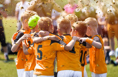 Kids in sports team. Happy boys in football team. Children sports education program. Children football school academy. Boys celebrate success in sports teamの写真素材
