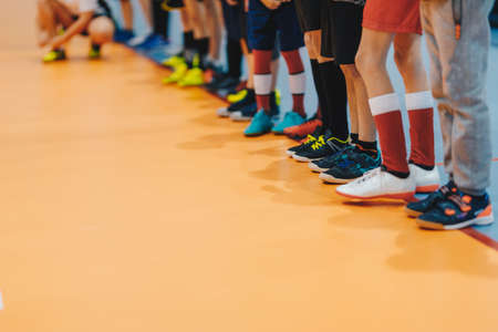 Sporty school kids standing in a line at physical education class. Legs of kids on sports indoor classの写真素材