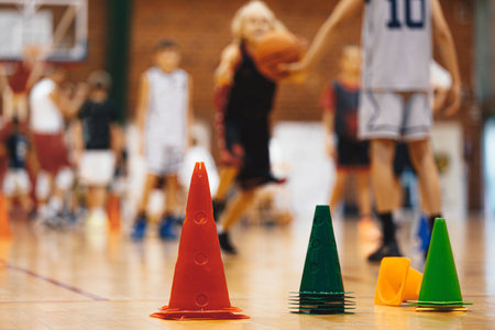 Basketball training session for youth. School sports class. Junior level basketball player bouncing basketball. Young basketball player with classic ballの写真素材