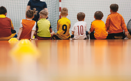 Little boys at class with young physical education teacher. Happy kids at school sports hall. Children at sports training practiceの写真素材