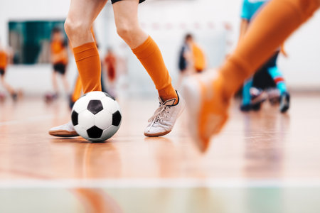Indoor soccer sports hall. Football futsal player, ball, futsal floor. Sports background. Youth futsal league. Indoor football players with classic soccer ball.の写真素材
