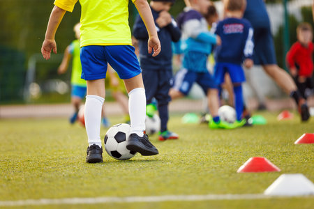 Sports Skills Training Session. Players Training on the Field. Soccer Obstacle Course. Grass Football Field. Coaching Soccer Gear Equipment for Field Trainingの写真素材