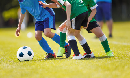 Football Soccer Match for Children. Kids Playing Soccer Game Tournament. Boys Running and Kicking Football. Youth Soccer Coach in the Backgroundの写真素材