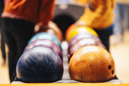 Colorful Bowling Balls in Alley. Family Bowling Entertainment and Recreational Indoor Sports...