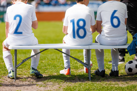 Youth Soccer Substitutes â€“ Kids Sitting on Bench During Football Match. Junior Sports, Team...