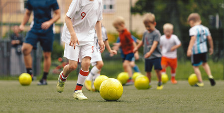 Children Football Training with Yellow Balls; Youth Soccer Drills and Skill Development for Kids on the Fieldの写真素材