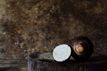 Taro placed on the chopping block in vintage style.の写真素材