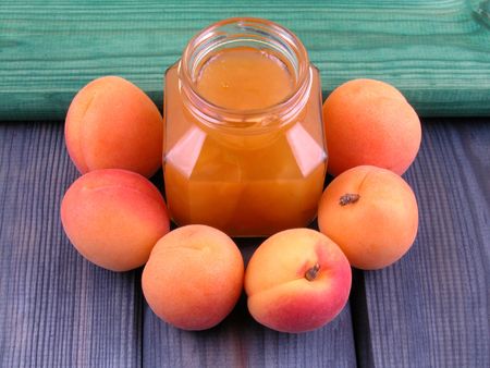 jar of apricot jam and some fresh apricotsの写真素材
